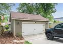 Spacious detached garage with an automatic door and adjacent parking area at 1232 Lucile Sw Ave, Atlanta, GA 30310