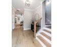 Elegant foyer with hardwood floors, staircase, designer light fixture, and neutral paint at 2561 Adair Ridge Ct, Decatur, GA 30034