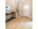 Inviting foyer features hardwood floors, stylish console table, and staircase at 2561 Adair Ridge Ct, Decatur, GA 30034