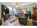 Cozy living room with wood-look flooring, a ceiling fan, and comfortable seating at 3620 Darwin Pl, Duluth, GA 30096
