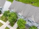 A top-down view of a townhome showing roof detail, driveway, and surrounding lush greenery at 5843 Taka Ln, Lithonia, GA 30038