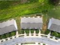 Overhead shot of townhomes with well-manicured lawns in a neighborhood with curved streets at 5843 Taka Ln, Lithonia, GA 30038
