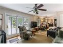 Cozy living room featuring hardwood floors, a ceiling fan, and access to the backyard at 1263 Blueberry Trl, Decatur, GA 30033