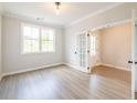 Bedroom features modern flooring, neutral paint, large window, and an open doorway at 1731 Fulmont Cir, Mableton, GA 30126