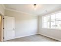 Bright bedroom features modern flooring, trim, large window, and neutral paint at 1731 Fulmont Cir, Mableton, GA 30126
