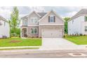 Two-story home with brick accents, attached two-car garage, and landscaped front yard at 1731 Fulmont Cir, Mableton, GA 30126