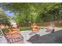 Inviting backyard with gravel fire pit, seating, and lush landscaping for relaxing outdoor living at 410 Sheringham Ct, Roswell, GA 30076