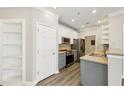 Charming kitchen with updated appliances, grey cabinets, and white shelving at 4203 Stratford Commons # 4203, Decatur, GA 30033