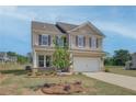 Inviting two-story home with neat landscaping, a lawn, and an attached garage at 568 Teversham Dr, Mcdonough, GA 30253