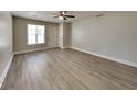 Spacious living room with wood-look floors, neutral paint, and ample natural light at 1236 Pinedale Nw Cir, Conyers, GA 30012