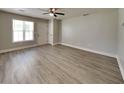 Spacious living room with wood-look floors, neutral paint, and ample natural light at 1236 Pinedale Nw Cir, Conyers, GA 30012