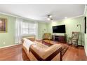 Inviting living room featuring hardwood floors, a comfortable couch, and a ceiling fan at 3149 Buford Ne Hwy # 2, Atlanta, GA 30329