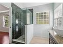 Modern bathroom featuring a glass-enclosed shower, granite countertop, and stylish fixtures at 4046 Water Hole Ct, Douglasville, GA 30135
