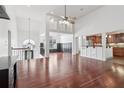 Spacious living room with hardwood floors, high ceilings, and an open layout to the kitchen at 4046 Water Hole Ct, Douglasville, GA 30135