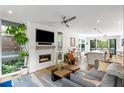 Open concept living room with fireplace, large windows and adjacent kitchen space at 670 Willoughby Ne Way, Atlanta, GA 30312