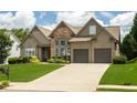 Charming home featuring a well-manicured lawn, stone accents, and an attached two-car garage at 1511 Rocky Knoll Ln, Dacula, GA 30019