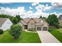 Charming home featuring a well-manicured lawn, stone accents, and an attached two-car garage at 1511 Rocky Knoll Ln, Dacula, GA 30019