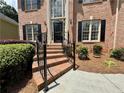 Brick steps with iron railing lead to the front door of this elegant home at 851 Millvale Pl, Lawrenceville, GA 30044