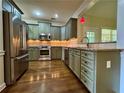 Updated kitchen with stainless steel appliances and granite countertops at 851 Millvale Pl, Lawrenceville, GA 30044