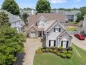 Aerial view of a charming two-story home with stone accents and a well-manicured lawn at 1472 Lynchburg Pl, Marietta, GA 30062