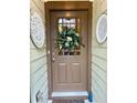 Inviting brown front door with decorative wreath and stylish decorative accents at 3202 Saute Way, Avondale Estates, GA 30002