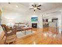 Bright living room with hardwood floors, fireplace, and open view into dining area at 3202 Saute Way, Avondale Estates, GA 30002