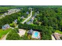 Aerial view of neighborhood pool, surrounded by trees and houses at 733 Exchange Mill Pl, Dacula, GA 30019