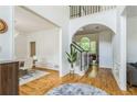 Elegant foyer showcasing hardwood floors, staircase, dining room, and living room with an archway at 1625 Hawkins Cove Trl, Roswell, GA 30076