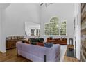 Spacious living room with high ceilings, large windows, hardwood floors, and contemporary furnishings at 1625 Hawkins Cove Trl, Roswell, GA 30076
