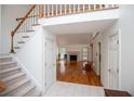 Spacious entryway with view into the living room featuring hardwood floors and fireplace at 7392 N Mitchell N Ct, Villa Rica, GA 30180