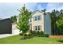 Charming two-story brick home with a well-manicured lawn and a two-car garage at 302 Aspen Valley Ln, Dallas, GA 30157
