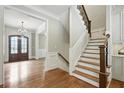 Inviting foyer with hardwood floors, staircase, and a glimpse of the elegant chandelier at 400 Mabry Pl, Atlanta, GA 30319
