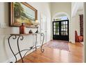 Elegant foyer showcasing hardwood floors, a stylish console table, and a striking front door at 6017 Chestatee Creek Nw Ct, Acworth, GA 30101