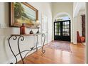 Inviting foyer featuring hardwood floors, a decorative table, and a glimpse of the outdoors through elegant glass doors at 6017 Chestatee Creek Nw Ct, Acworth, GA 30101