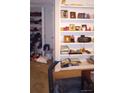 Living room displaying a built-in bookcase with decor items, books, and a glimpse of a walk-in closet at 80 Place Fontaine, Lithonia, GA 30038