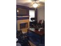 Cozy living room with a stone fireplace and a large television mounted above the mantle at 80 Place Fontaine, Lithonia, GA 30038