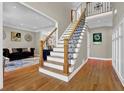 Inviting foyer with hardwood floors, staircase with iron railing, and elegant decor at 1875 Edgemont Ct, Cumming, GA 30041