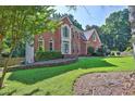 Beautiful brick home featuring lush landscaping and a well-maintained lawn at 1875 Edgemont Ct, Cumming, GA 30041