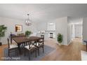 Bright dining room seamlessly connecting to the kitchen, featuring elegant light fixture and wood floors at 3119 Medley Rdg, Decatur, GA 30033