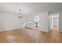 Open-concept living room with bright, neutral walls and elegant light wood flooring leading to other rooms at 3119 Medley Rdg, Decatur, GA 30033