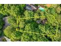 Aerial view of property boundaries in a wooded area with a pool and neighboring houses at 3841 Brooklawn Ne Ct, Brookhaven, GA 30319