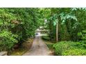 A long driveway leads up to this house, surrounded by lush trees and greenery at 3841 Brooklawn Ne Ct, Brookhaven, GA 30319