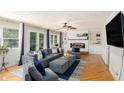 Comfortable living room with a fireplace, built-in shelves, and hardwood floors at 573 Hastings Way, Jonesboro, GA 30238