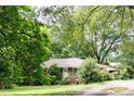 Charming brick home with lush landscaping and a welcoming entrance at 127 Perry St, Loganville, GA 30052