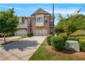 Charming brick townhome with two-car garage and well-maintained lawn at 1858 Glenview Park Cir, Duluth, GA 30097