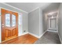 Inviting foyer featuring hardwood floors, a decorative front door, and fresh paint at 2930 Heather Stone Way, Lawrenceville, GA 30043