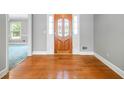Light filled foyer showcasing hardwood floors and a decorative front door at 2930 Heather Stone Way, Lawrenceville, GA 30043