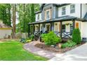 Inviting front porch with decorative trim, landscaped yard and a charming walkway leading to the entrance at 3139 Fairview Dr, Snellville, GA 30078