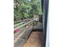 View of a wooden deck showcasing a casual outdoor seating area and surrounding green space at 4059 Heritage Valley Ct, Norcross, GA 30093