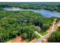 Aerial view of 410 Iroquois Court, Covington, Georgia, nestled among trees and near a lake at 410 Iroquois Ct, Covington, GA 30014